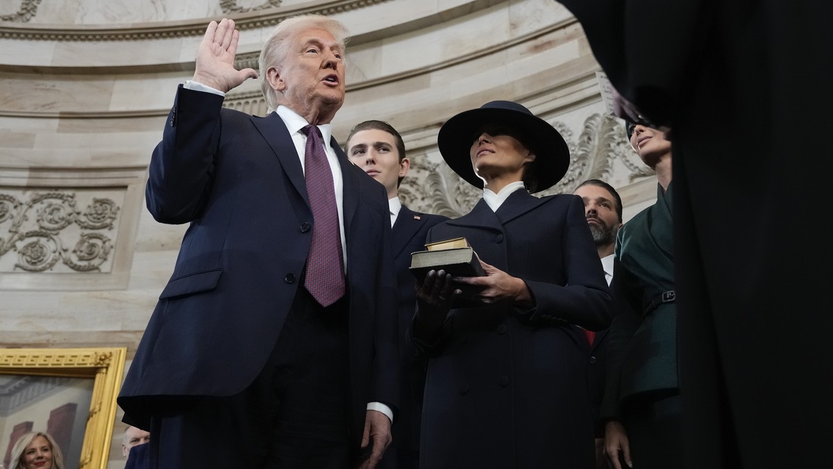 epa11839382 Donald Trump is sworn in as the 47th president of the United States by Chief Justice John Roberts as Melania Trump holds the Bible during the 60th Presidential Inauguration in the Rotunda  ...