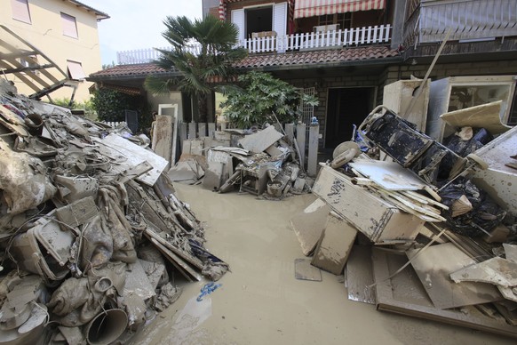 Household goods are piled outside a building after heavy flooding, in Faenza, Italy, Monday, May 22, 2023. Climate experts say the floods that sent rivers of mud tearing through towns in Italy?s north ...