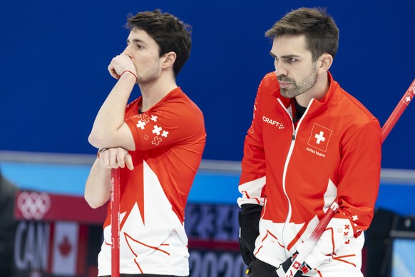 Switzerland skip Peter De Cruz, right, and his teammate Benoit Schwarz, left, observe during the men&#039;s Round Robin game between the Switzerland and USA at the National Aquatics Centre at the 2022 ...