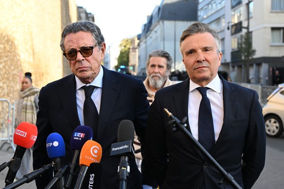 Former French President Nicolas Sarkozy's lawyers Jean-Michel Darrois, left, and Christophe Ingrain answer reporters outside La Sante prison, Tuesday, Oct. 21, 2025 in Paris. (AP Photo/Emma Da Si ...