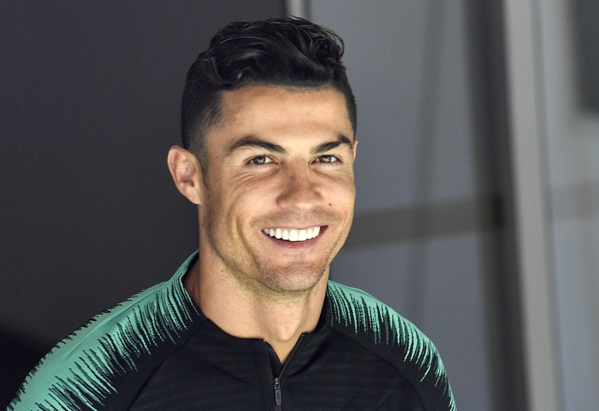 FILE - In this June 8, 2019, file photo, Portugal's Cristiano Ronaldo smiles when he arrives to a training session at the Bessa stadium in Porto, Portugal. Soccer star Cristiano Ronaldo wonÄôt f ...