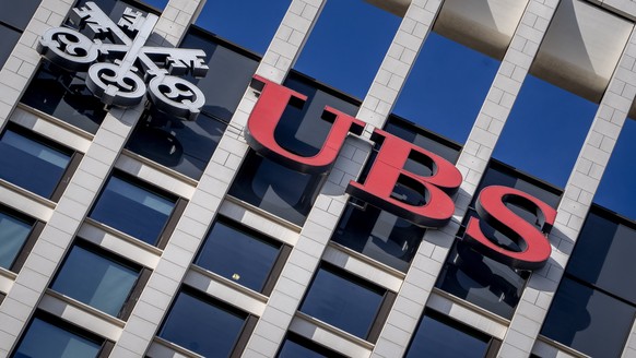 FILE - The logo of Swiss bank UBS is fixed on a building where the bank has offices in Frankfurt, Germany, Nov. 8, 2022. Swiss banking giant UBS will pay nearly $400 million in fines to U.S., Swiss an ...