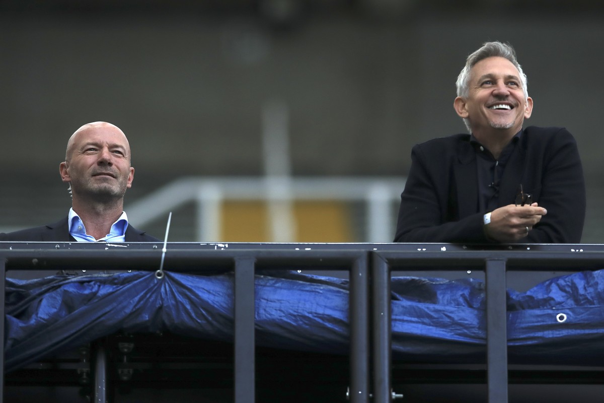 FILE - TV soccer pundits and former soccer players Alan Shearer, left, and Gary Lineker watch the FA Cup sixth round soccer match between Newcastle United and Manchester City at St. James' Park i ...