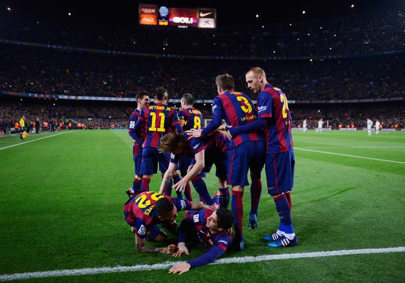 BARCELONA, SPAIN - MARCH 22: Luis Suarez of Barcelona (grounded) celebrates with team mates as he scores their second goal during the La Liga match between FC Barcelona and Real Madrid CF at Camp Nou  ...