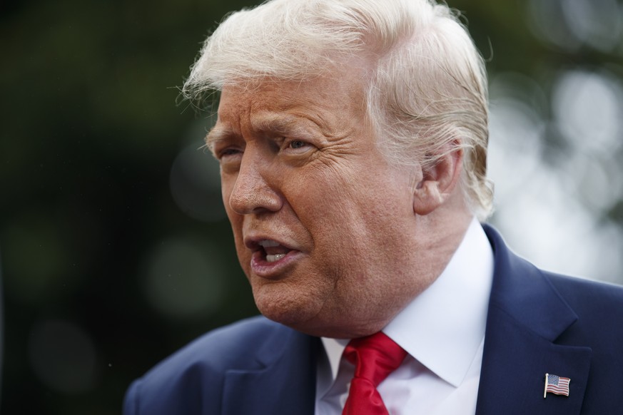 epa08538920 US President Donald J. Trump responds to a question from the news media as he walks to Marine One on the South Lawn of the White House in Washington, DC, USA, 10 July 2020. President Trump ...