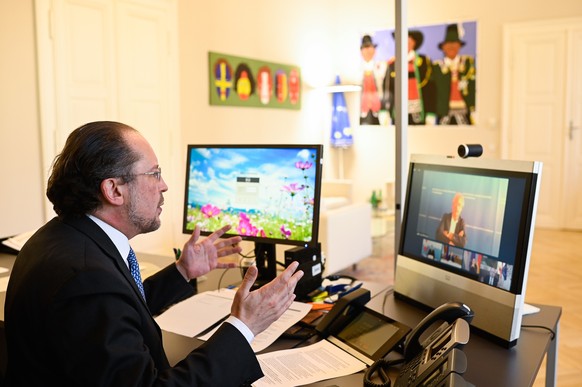 epa08375093 Austrian Foreign Minister Alexander Schallenberg attends a video conference of a four country Foreign Ministers meeting between Austria, Germany, Liechtenstein, Switzerland in Vienna, Aust ...