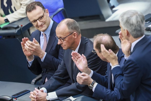epa12077875 German newly elected Chancellor and Christian Democratic Union (CDU) party chairman Friedrich Merz (2-L) receives applause after the second round of voting at the Bundestag in Berlin, Germ ...