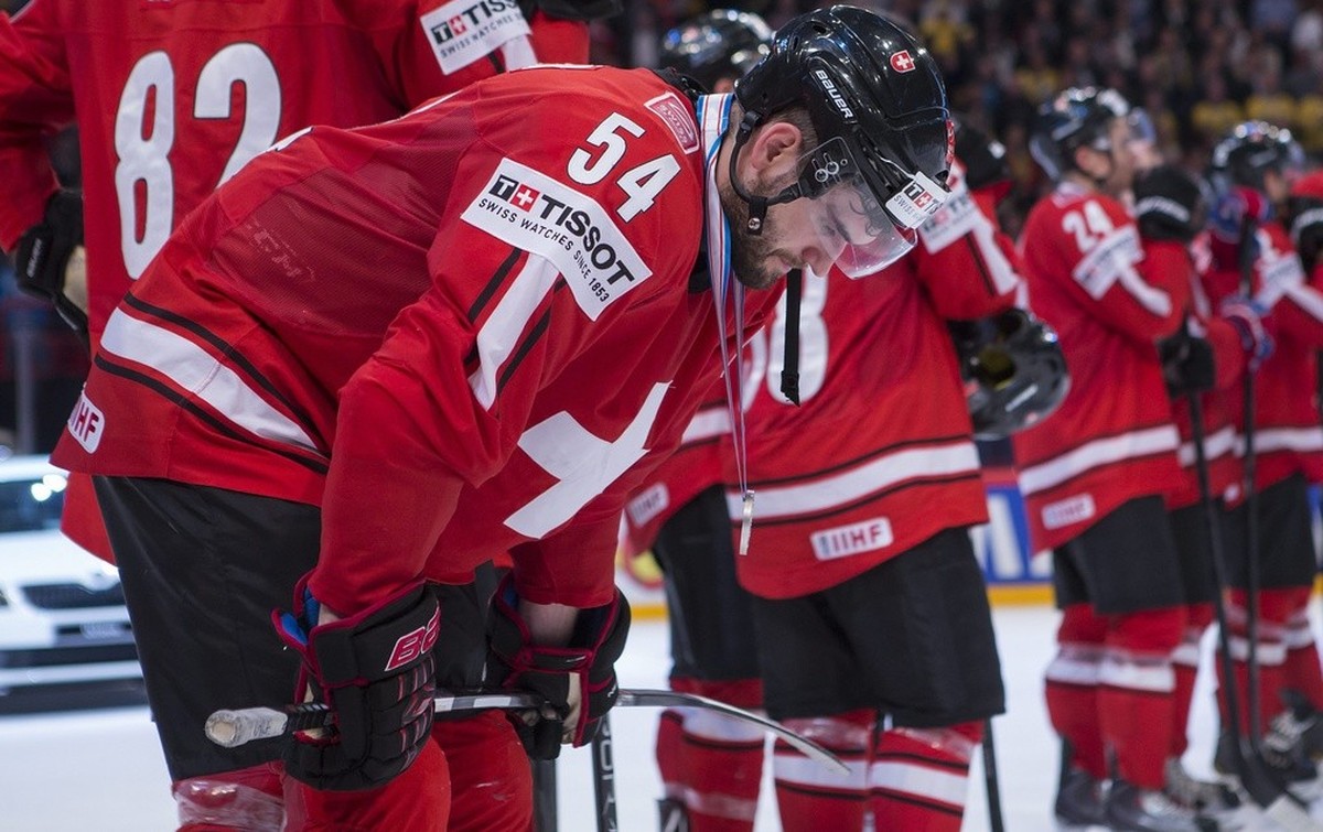 Switzerland's Philippe Furrer (54) looks dejected with his teammates after losing in the Gold Medal game between Switzerland and Sweden at the IIHF 2013 Ice Hockey World Championships at the Glob ...