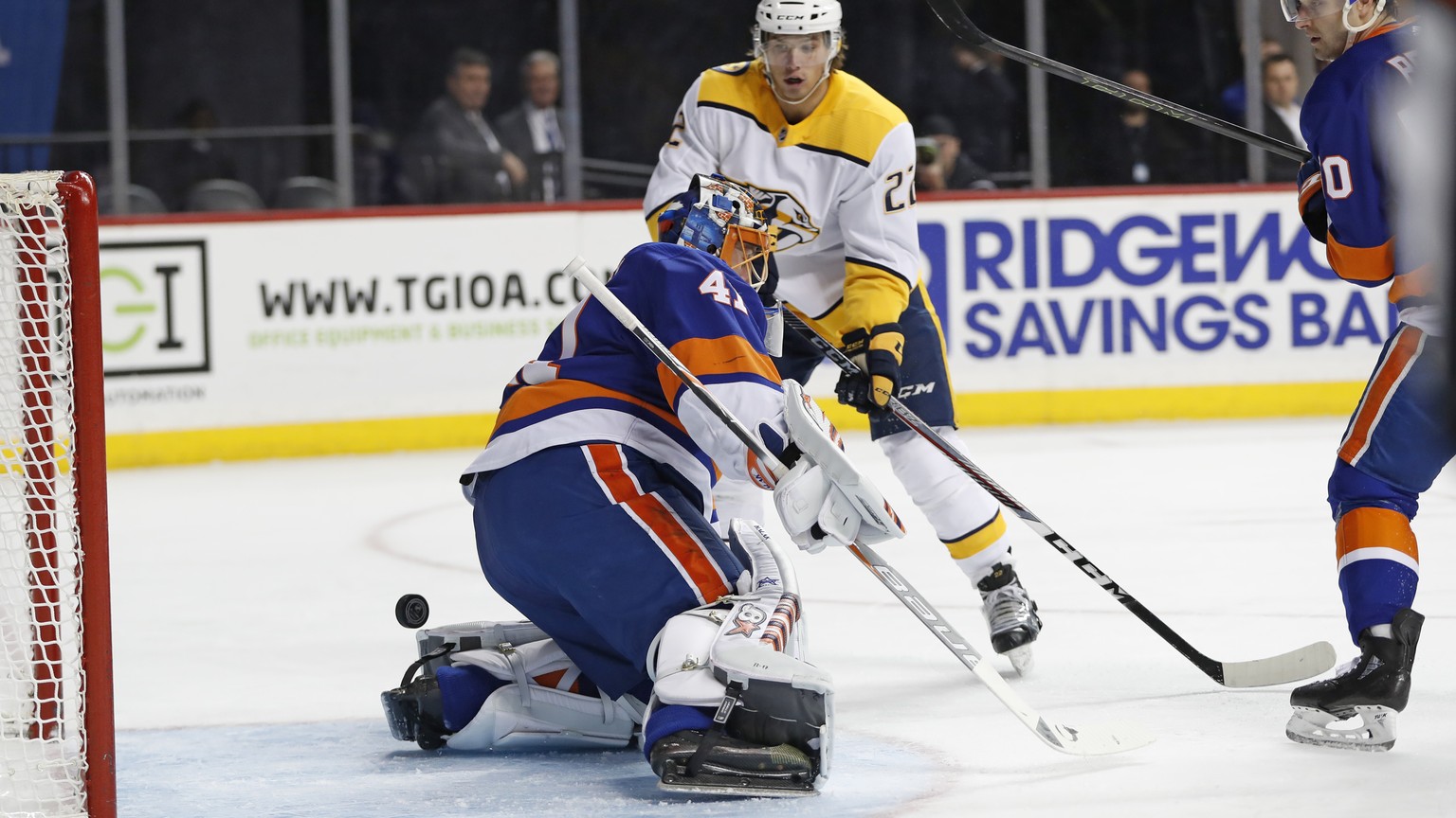 Nashville Predators left wing Kevin Fiala (22) of Switzerland watches as his shot slips behind New York Islanders goaltender Jaroslav Halak (41) of Slovakia during the first period of an NHL hockey ga ...