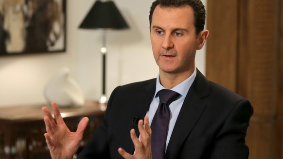 epa05158104 A handout photograph released on 13 February 2016 by the official Syrian Arab News Agency (SANA) shows Syrian President Bashar Assad giving an interview to the AFP news agency, in Damascus ...