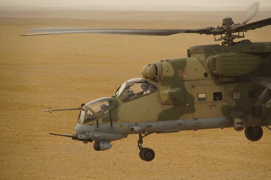 In this Friday, Sept. 15, 2017 photo Russian military helicopter flies over a desert in Deir es-Zor province, Syria. A U.S.-backed force in Syria said a Russian airstrike wounded six of its fighters S ...