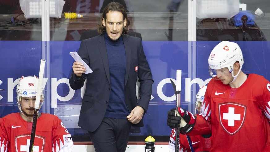 Patrick Fischer, head coach of Switzerland national ice hockey team, talks between Switzerland&#039;s forward Noah Rod, let, and Switzerland&#039;s forward Joel Vermin, right, during the IIHF 2021 Wor ...