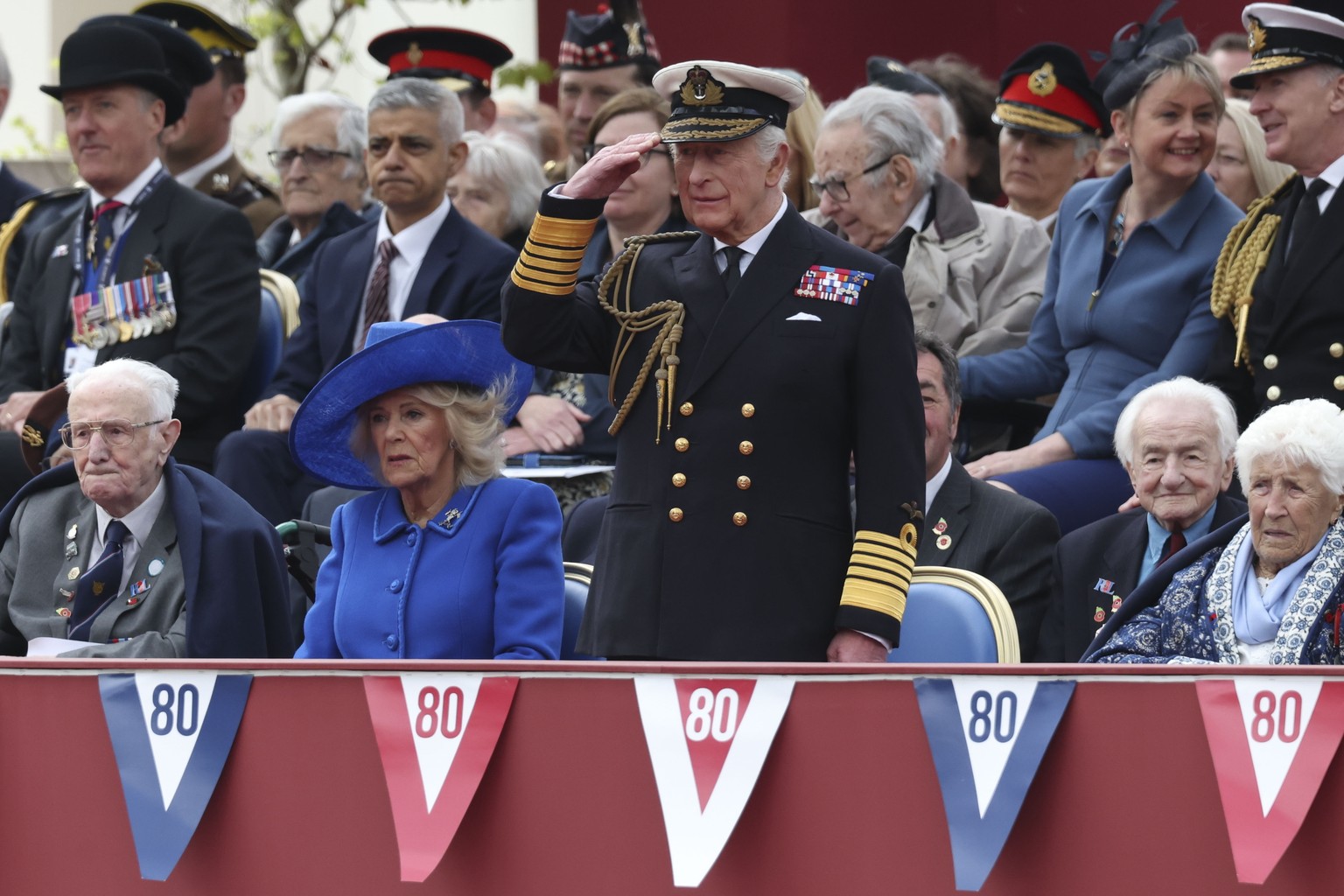 epa12075298 Britain&#039;s King Charles III (C) takes the salute as Queen Camilla (2-L) watches the military procession to commemorate the 80th anniversary of Victory in Europe (VE Day) in London, Bri ...