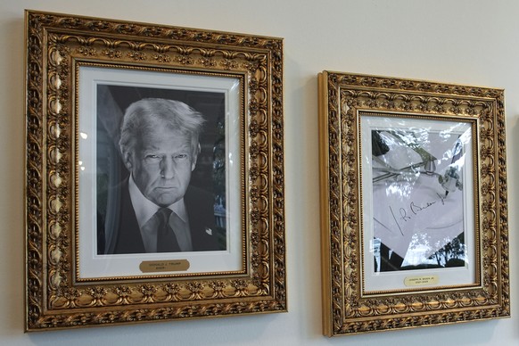 epa12405232 A portrait of US President Donald Trump (L) hangs beside a picture of an autopen of former US President Joe Biden&#039;s signature as part of the &#039;Presidential Walk of Fame&#039; inst ...
