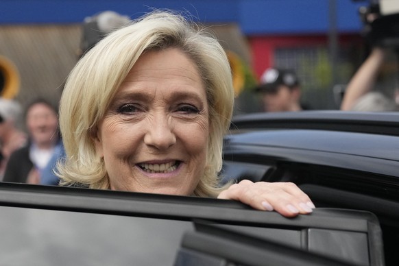 French far right leader Marine Le Pen leaves after voting in the first round of the parliamentary election, Sunday, June 30, 2024 in Henin-Beaumont, northern France. France is holding the first round  ...
