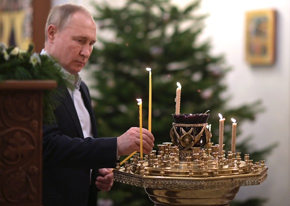 epa09671342 Russian President Vladimir Putin attends the Orthodox Christmas mass at the Church of the Savior of the Miraculous Image, at the Novo-Ogaryovo state residence outside Moscow, Russia, 07 Ja ...