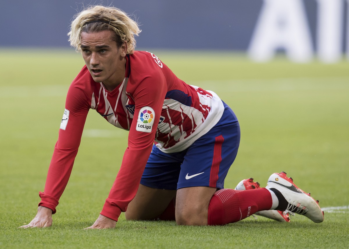 Madrid's Antoine Griezmann sits on the pitch during the Audi Cup semifinal soccer match between Atletico Madrid and SSC Napoli in the Allianz Arena in Munich, Germany, Tuesday, Aug. 1 2017. (Sven ...