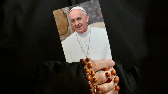 KEYPIX - epa11938675 A nun holds a picture of Pope Francis and a rosary as faithful attend a Rosary prayer for the health of the pontiff at St. Peter&#039;s Square in Vatican City, 03 March 2025. Pope ...