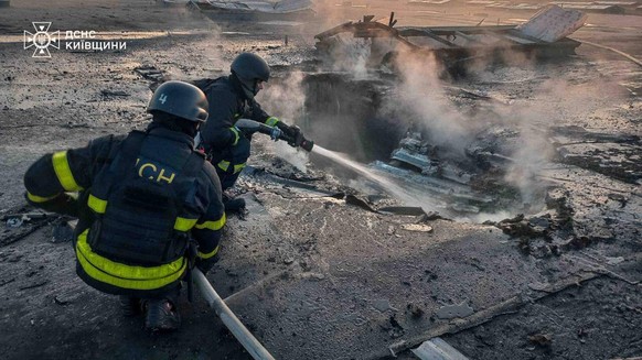In this photo provided by the Ukrainian Emergency Services on Wednesday, April 15, 2026, rescue workers put out a fire of building damaged after a Russian drone strike on Kyiv region, Ukraine. (Ukrain ...