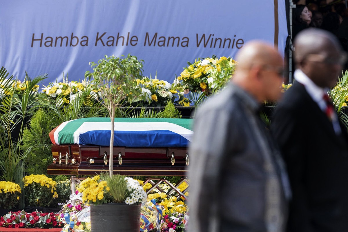 epa06668941 The coffin of Winnie Madikizela-Mandela stands in front of the words in Xhosa 'Go well mother Winnie' during the official state funeral at Orlando stadium in Soweto, Johannesburg ...