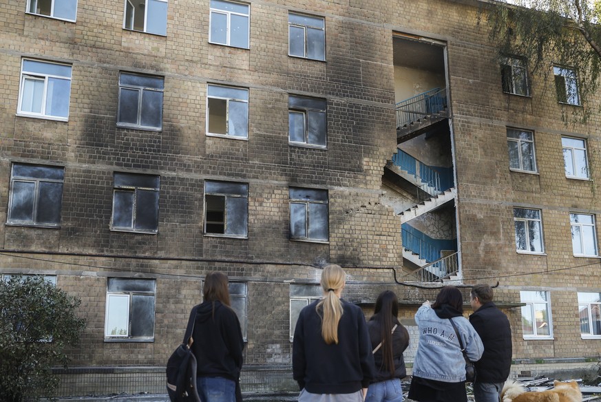 epa13274595 Local children stand near the site of a Russian drone strike on a school building in a residential area of Kyiv, Ukraine, 01 October 2026, amid the Russian invasion. No casualties or injur ...