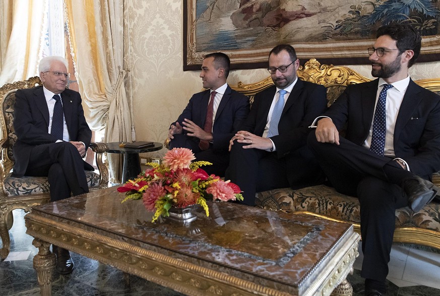 epa07786115 A handout photo made available by Quirinale Palace shows the President of the Republic Sergio Mattarella (L) with Luigi Di Maio M5S leader and his party members Francesco D&#039;Uva (R) an ...