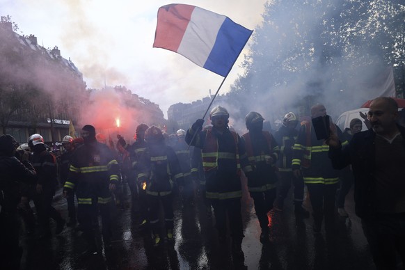 Rescue workers march during a demonstration, Monday, May 1, 2023 in Paris. French unions plan massive demonstrations around France to protest President Emmanuel Macron&#039;s recent move to raise the  ...