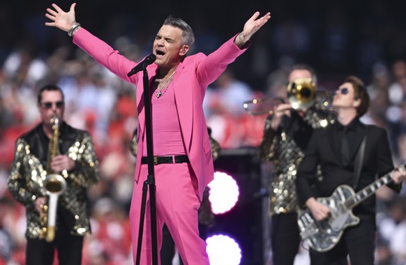 Entertainer Robbie Williams performs ahead of the AFL Grand Final match between the Geelong Cats and the Sydney Swans at the Melbourne Cricket Ground in Melbourne, Australia, Saturday, Sept. 24, 2022. ...