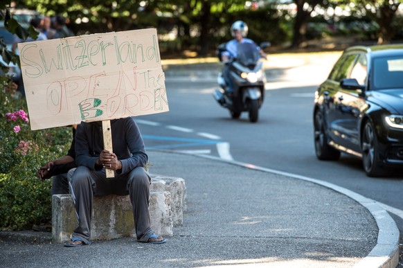 Migranten halten ein Schild mit der Aufschrift &quot;Schweiz oeffne die Grenze&quot; in Ponte Chiasso, Italien am Mittwoch, 7. September 2016. Die Migranten demonstrieren gegen Gewalt von Beamten und  ...