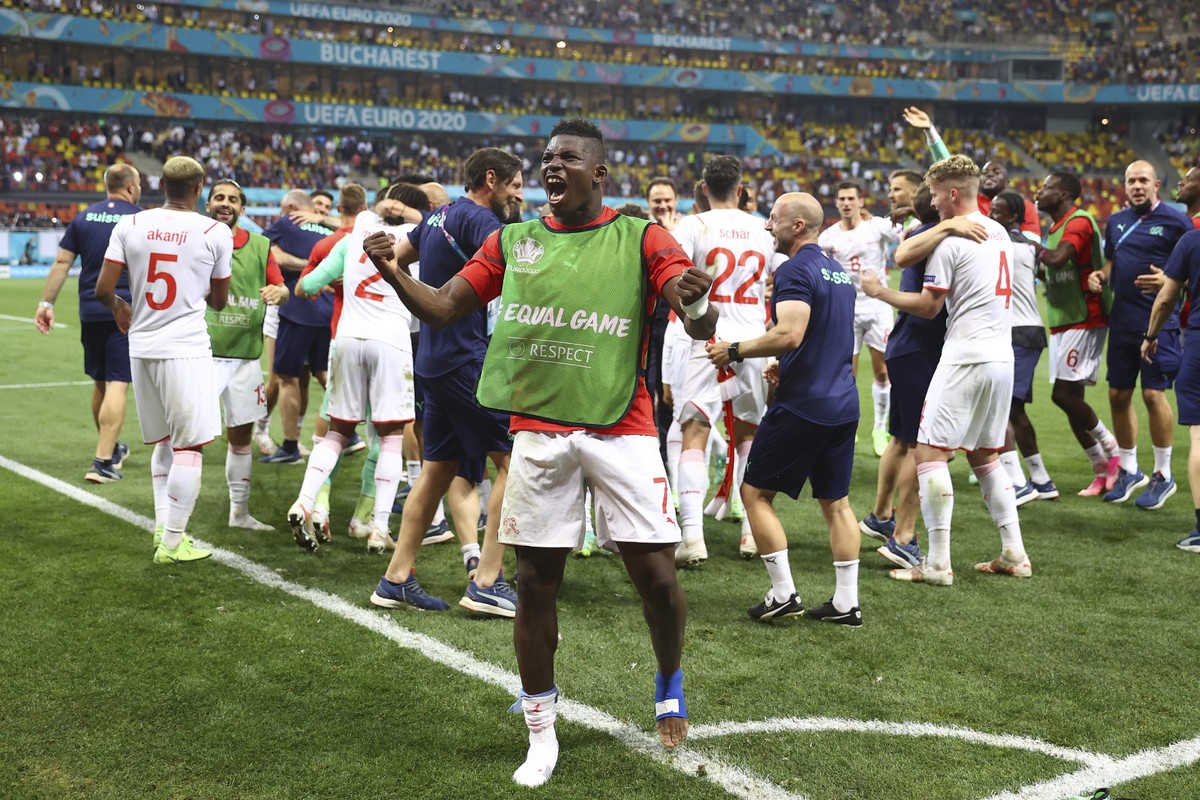 Switzerland's Breel Embolo celebrates end of the Euro 2020 soccer championship round of 16 match between France and Switzerland at the National Arena stadium, in Bucharest, Romania, Tuesday, June ...