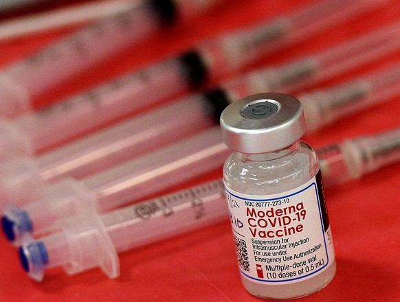FILE - Syringes and a vial of the Moderna COVID-19 vaccine are displayed at a mass COVID-19 vaccination site in Batavia, Ill., on March 19, 2021. Moderna hopes to offer updated COVID-19 boosters in th ...