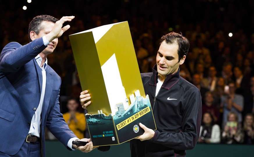 epa06533811 Roger Federer of Switzerland receives a trophy for getting the highest ranking again at the ATP after winning from Robin Haase of the Netherlands in their quarter final match of the ABN AM ...