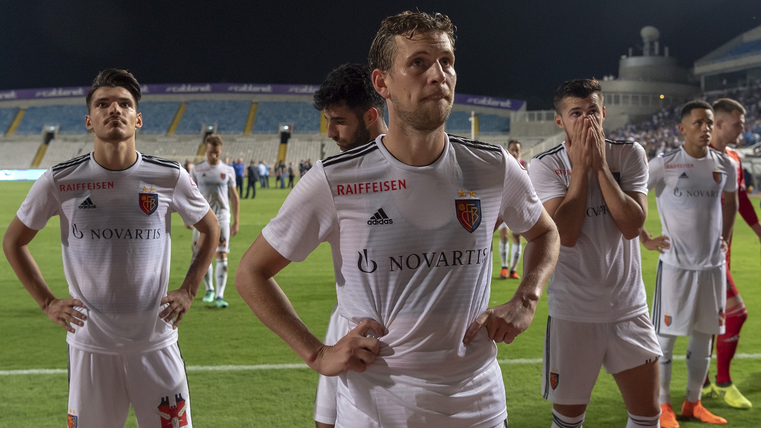 Basel&#039;s disappointed players leave the pitch after the UEFA Europa League play-off second leg match between Cyprus&#039; Apollon Limassol FC and Switzerland&#039;s FC Basel 1893 in the GSP stadiu ...