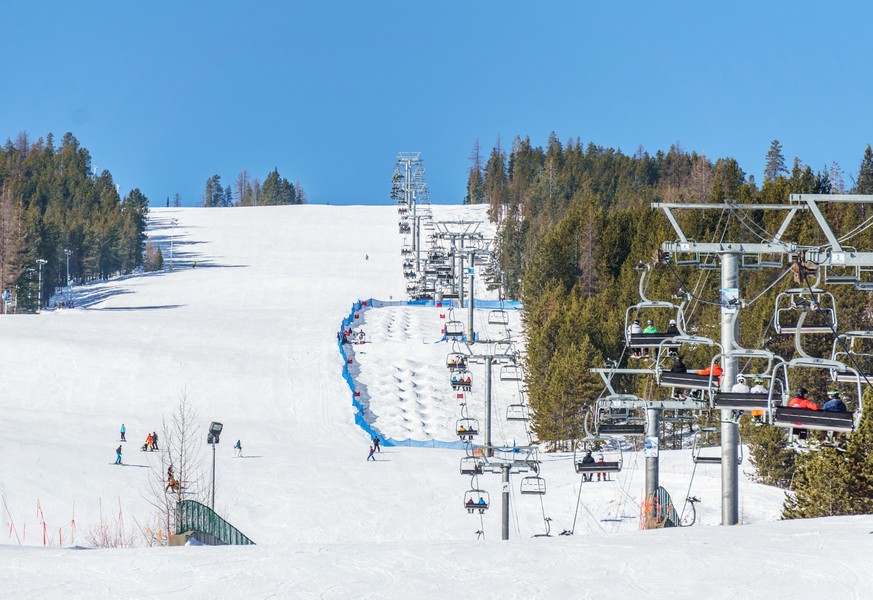 KIMBERLEY, CANADA - MARCH 22, 2019: Mountain Resort view early spring people skiing