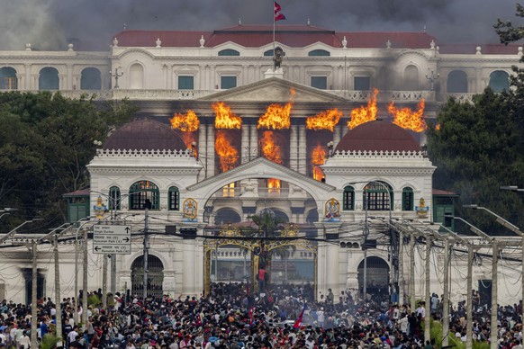 KEYPIX - epa12364471 Fire and smoke rise from the Singha Durbar palace, which houses government and parliament buildings, after protesters stormed the premises during violent demonstrations in Kathman ...