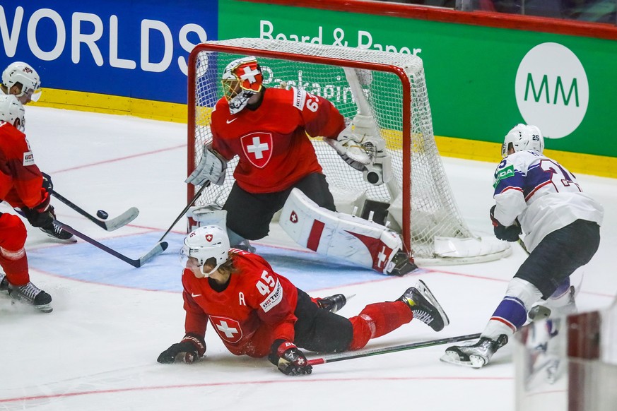 epa09978402 Michael Fora (bottom) of Switzerland in action during the IIHF Ice Hockey World Championship 2022 quarterfinals match between Switzerland and United States in Helsinki, Finland, 26 May 202 ...