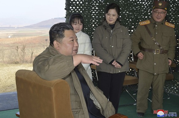 This photo provided on Nov. 19, 2022, by the North Korean government shows its leader Kim Jong Un, front, speaks, accompanied by his wife Ri Sol Ju, second from right, and his daughter, as Kim inspect ...