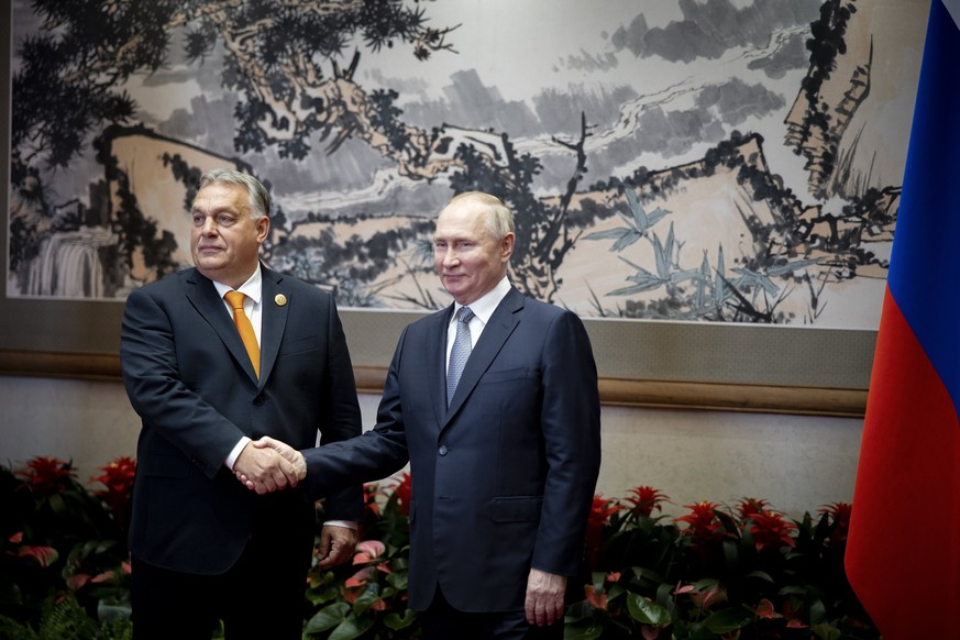 epa10923334 In this photo, released by the Hungarian Prime Minister's Press Office, we see Hungarian Prime Minister Viktor Orban (L) and Russian President Vladimir Putin shaking hands during their talks on the si ...