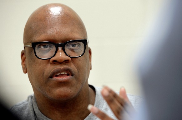 FILE - In this Aug. 26, 2014 file photo, Leon Brown speaks with a reporter at the Maury Correctional Institution in Maury, N.C., about his incarceration. Lawyers representing two former North Carolina ...