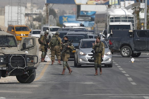 epa10495366 Israeli soldiers check Palestinian cars at a checkpoint at the entrance to the West Bank city of Jericho, Feb. 28, 2023, as Israeli troops tighten security in the area.  Israeli authority...
