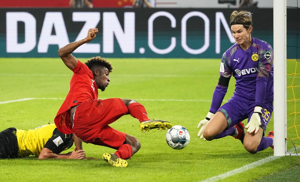 epa07755429 Bayern Munich's Kingsley Coman (L) in action against Dortmund's goalkeeper Marwin Hitz (R) during the German Supercup soccer match between Borussia Dortmund and Bayern Munich in  ...