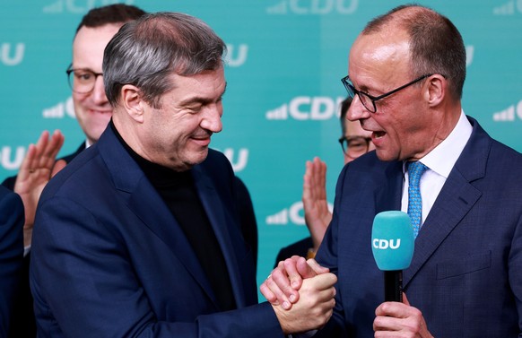 epa11919523 Chairman of Germany's Christian Democratic Union (CDU) Friedrich Merz (R) and State Premier of Bavaria and Christian Social Union (CSU) chairman Markus Soeder (L) celebrate during the ...