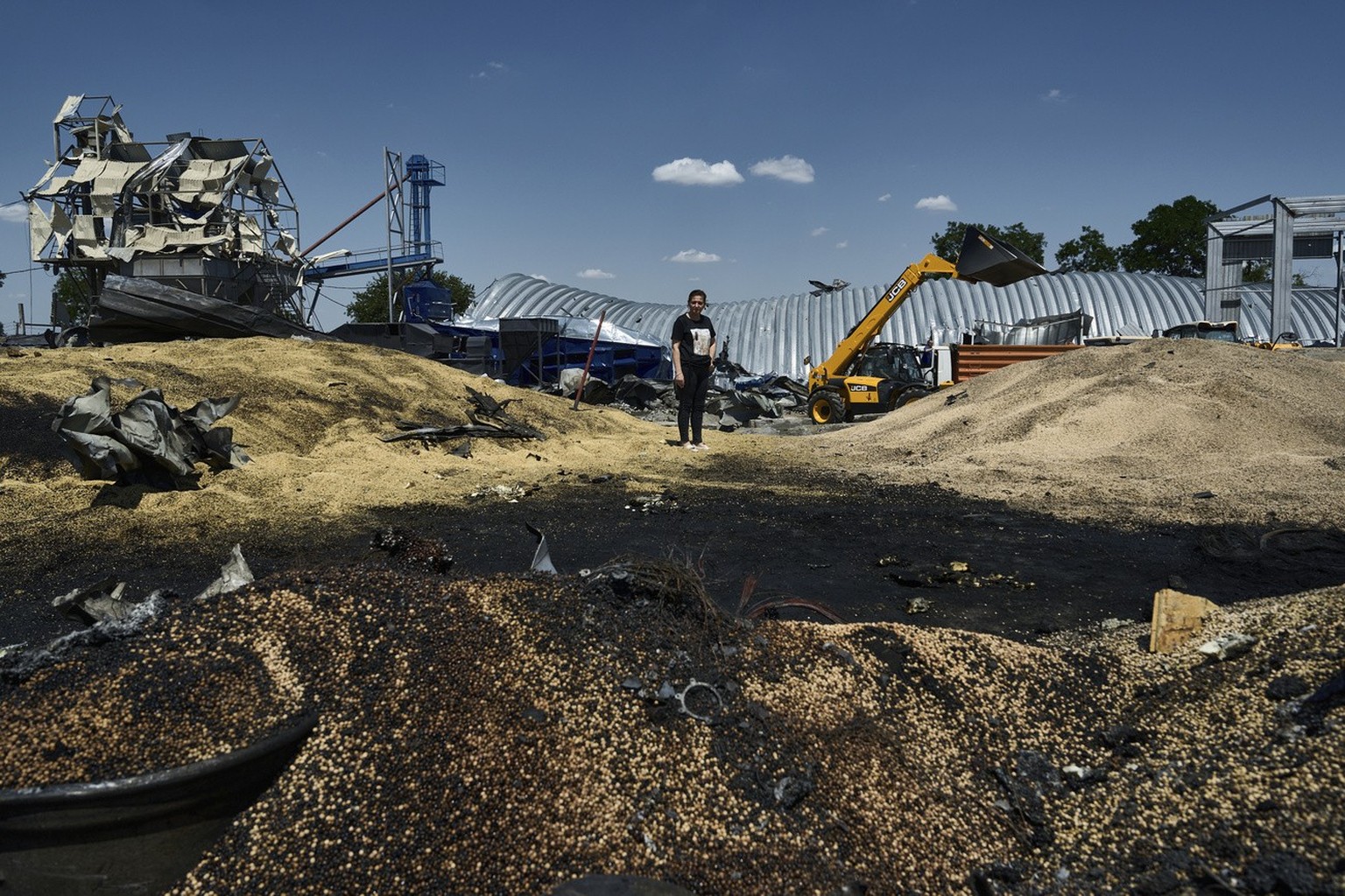 FILE - Olha stands among the rubble of a farm storage building destroyed in a Russian attack in the Odessa region, Ukraine, on July 21, 2023. Russia has repeatedly fired missiles and drones at Ukrainian po...