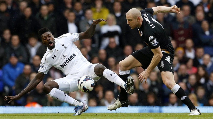 epa03629265 Emmanuel Adebayor (L) of Tottenham Hotspur vies for ball with Philippe Senderos (R) of Fulham FC during the English Premier League soccer match between Tottenham Hotspur and Fulham FC at t ...