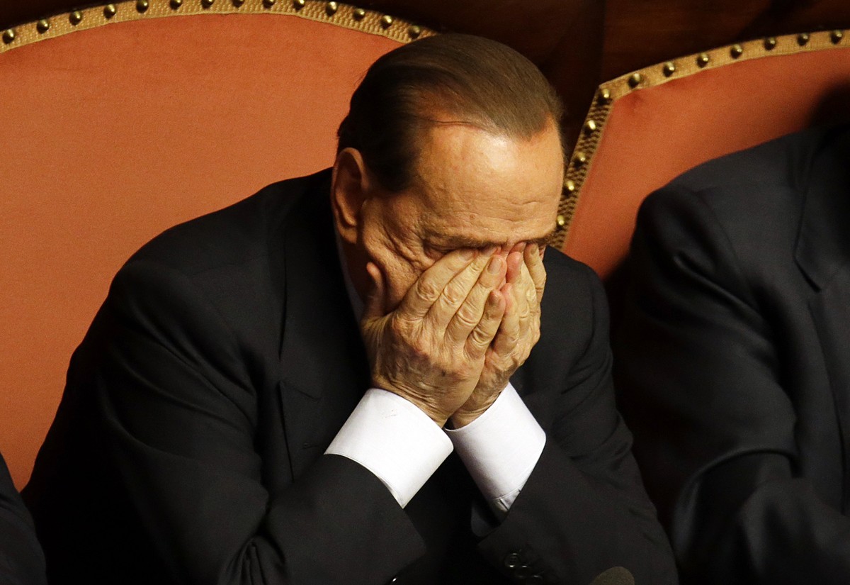 FILE - In this Wednesday, Oct. 2, 2013 file photo People of Freedom party leader Silvio Berlusconi rubs his eyes after delivering his speech at the Senate, in Rome. Italy's highest court was hear ...
