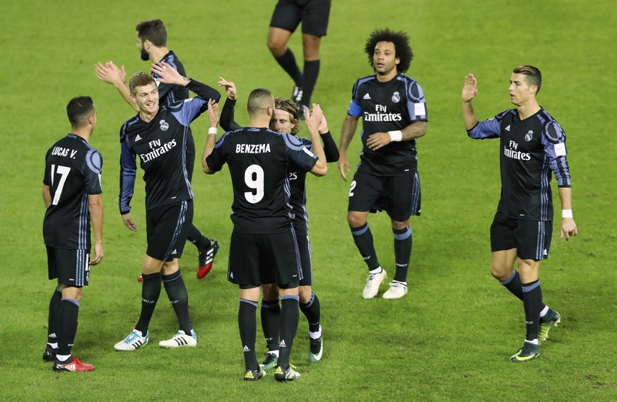 Real Madrid&#039;s Karim Benzema, number 9, is congratulated by teammates after scoring a goal during their semifinal match against Club America at the FIFA Club World Cup soccer tournament in Yokoham ...