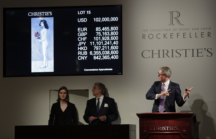 Global president of Christie&#039;s Jussi Pylkkanen, right, guides the bidding for Pablo Picasso&#039;s &quot;Fillette a la corbeille fleurie&quot; which sold for $102 million during an auction from t ...