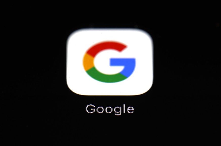 FILE - This March 19, 2018 file photo shows a Google app in Baltimore. Google says Apple has also revoked its access to a key developer tool, preventing its employees from testing new app features on  ...