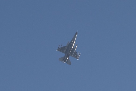 epa11718406 An Israeli F-16 fighter jet flies as an alarm for hostile aircraft (UAV) fire from Lebanon sounds above the city of Kiryat Yam, north of Haifa, Israel, 13 November 2024. According to the I ...