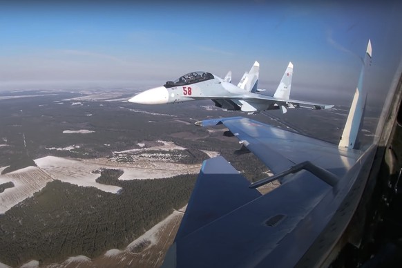 FILE - In this image from video provided by the Russian Defense Ministry Press Service on Feb. 17, 2022, Su-30 fighters of the Russian and Belarusian air forces fly in a joint mission during the Union ...